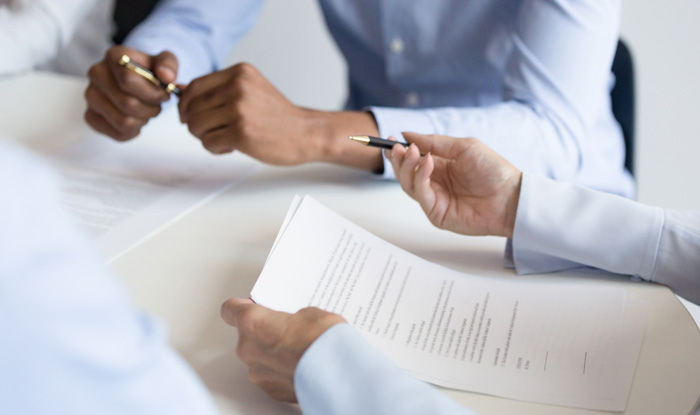 Business woman holding reading checking legal contract at group meeting
