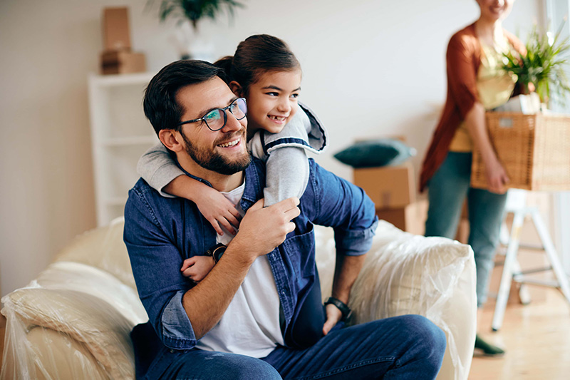 Embraced father and daughter enjoying at their new home