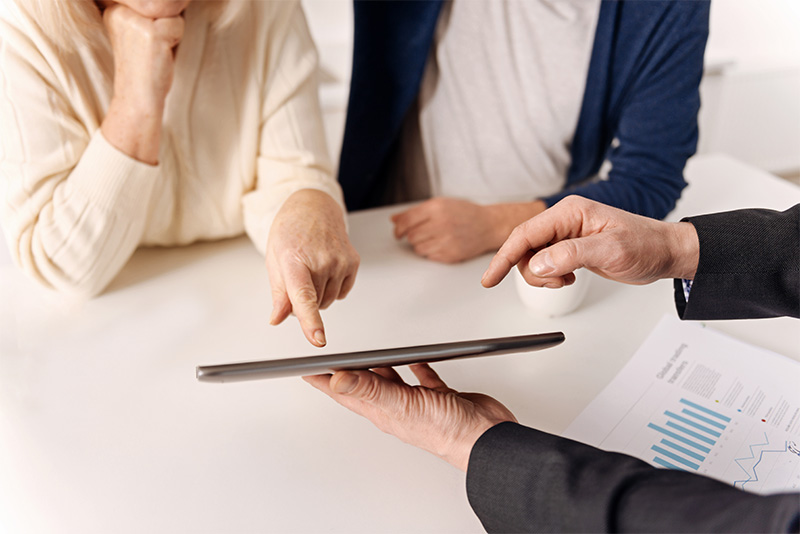 Helpful real estate agent working with aging couple of clients