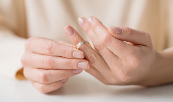 Woman divorcing and taking off wedding band