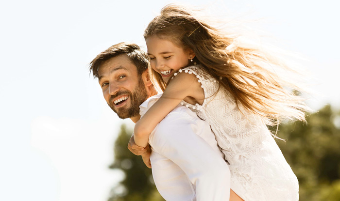 father daughter outside smiling