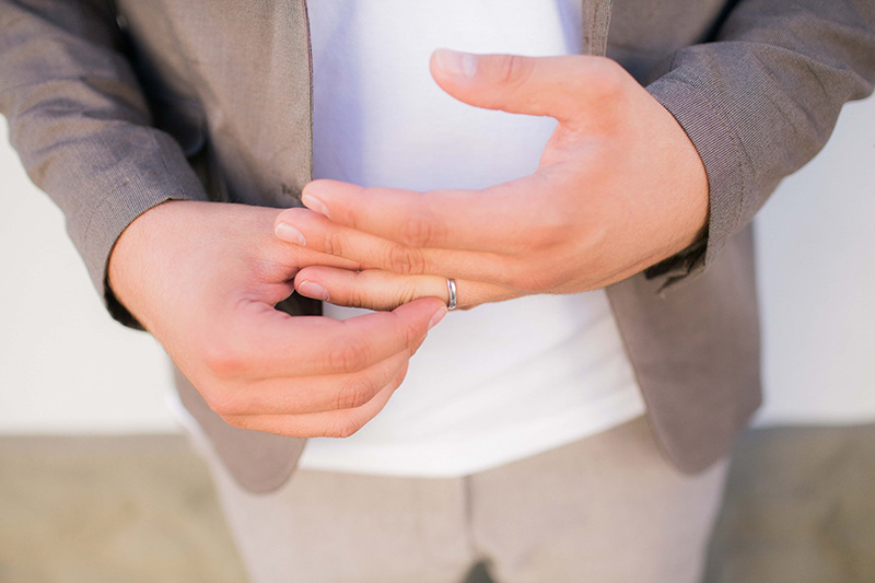 man taking off wedding ring