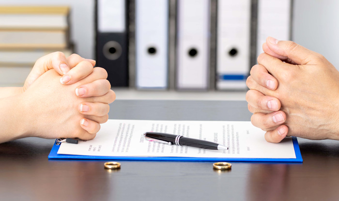two people getting ready to sign documents