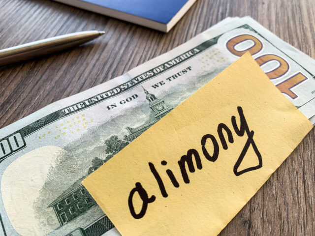 Payments alimony. Pile Dollars with sign alimony and money. Divorce and separation concept